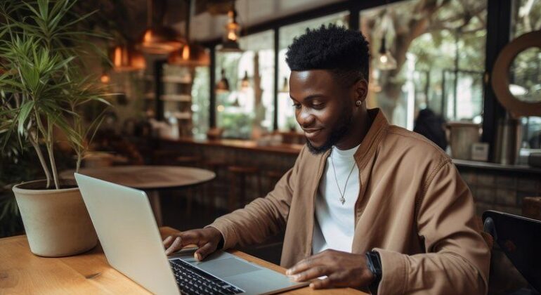 African man computer laptop coffee.